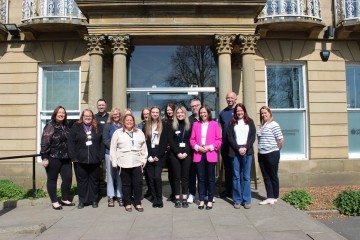 Sarah Smith MP for Hyndburn and Haslingden, staff from DWP, staff from CSNW, and partners of CSNW gather outside Elmfield Hall to celebrate the launch of the Accrington Youth Hub