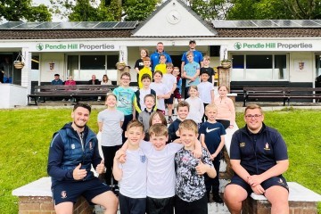 THOMAS TURNER LEFT AND TOBY BURROWS RIGHT OF PENDLE HILL PROPERTIES WITH CHILDREN WHO ATTENDED THEIR FREE CRICKET TRAINING SESSION AT PADIHAM.jpg.jpg