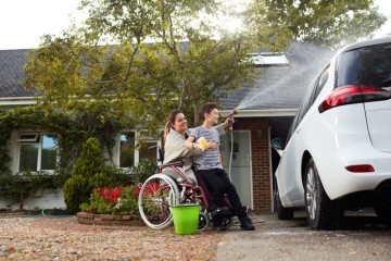 woman in wheelchair and boy washing car.jpg.jpg