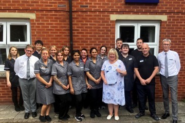 Image shows Helen Brown with Lovett employees celebrating the ISO accreditation SMALLER.jpg.jpg