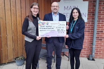 Corporate Fundraiser at Bury Hospice Nina Camplin receiving the donation from NLTGs Gareth Lindsay and Evie Crawshaw.jpg.jpg