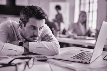 bored-1businessman-reading-e-mail-on-laptop-while-w-2024-12-13-21-05-28-utc.jpg.jpg