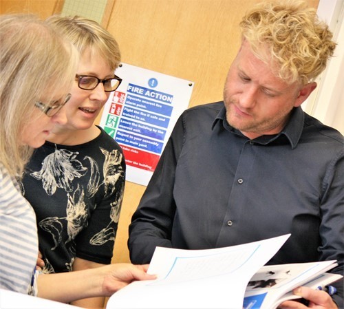 mark-hamblett-and-elaine-sutton-middle-looking-at-the-topic-work-children-have-produced-with-the-new-curriculum.jpg