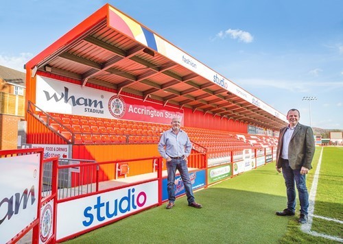 andy-holt-of-asfc-and-paul-kendrick-of-studio-retail-ltd-at-the-family-stand-at-accrington-stanley-fc-lo.jpg