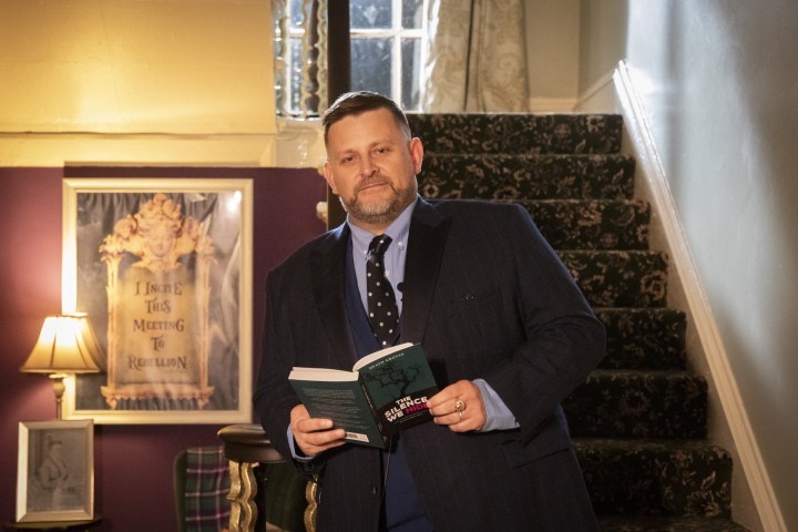 Author Heath Groves reading an extract from The Silence We Hide on the staircase of Moorside House.jpg.jpg
